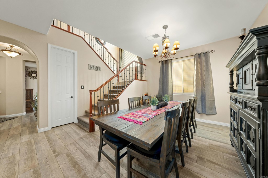 2781 Rambling Vista Road Chula Vista, CA 91915 - Photo 4 of 39 a view of a dining room with furniture and a chandelier