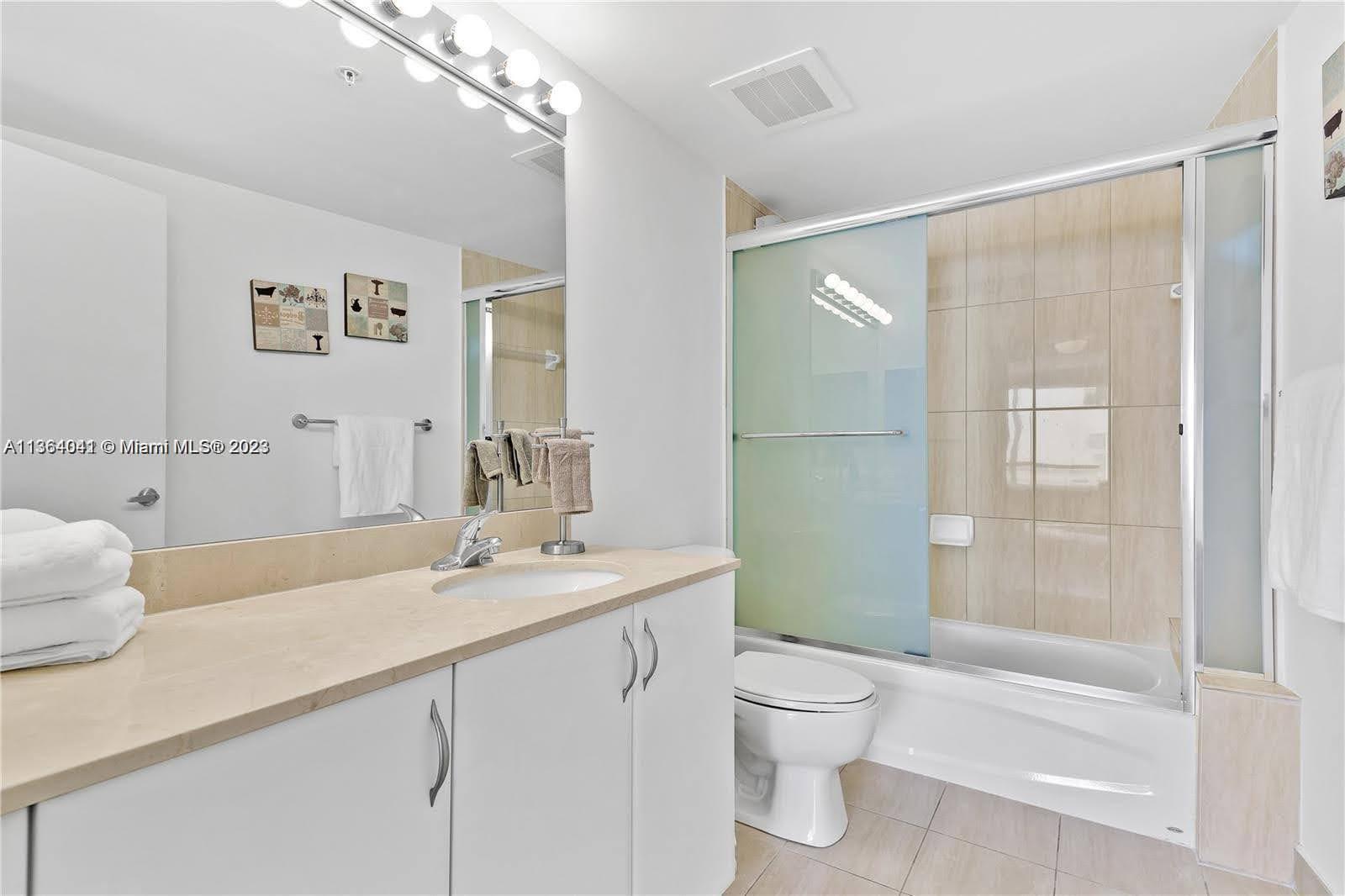Edgewater Miami, FL 33132 - Photo 3 of 11 a bathroom with a sink a toilet and shower