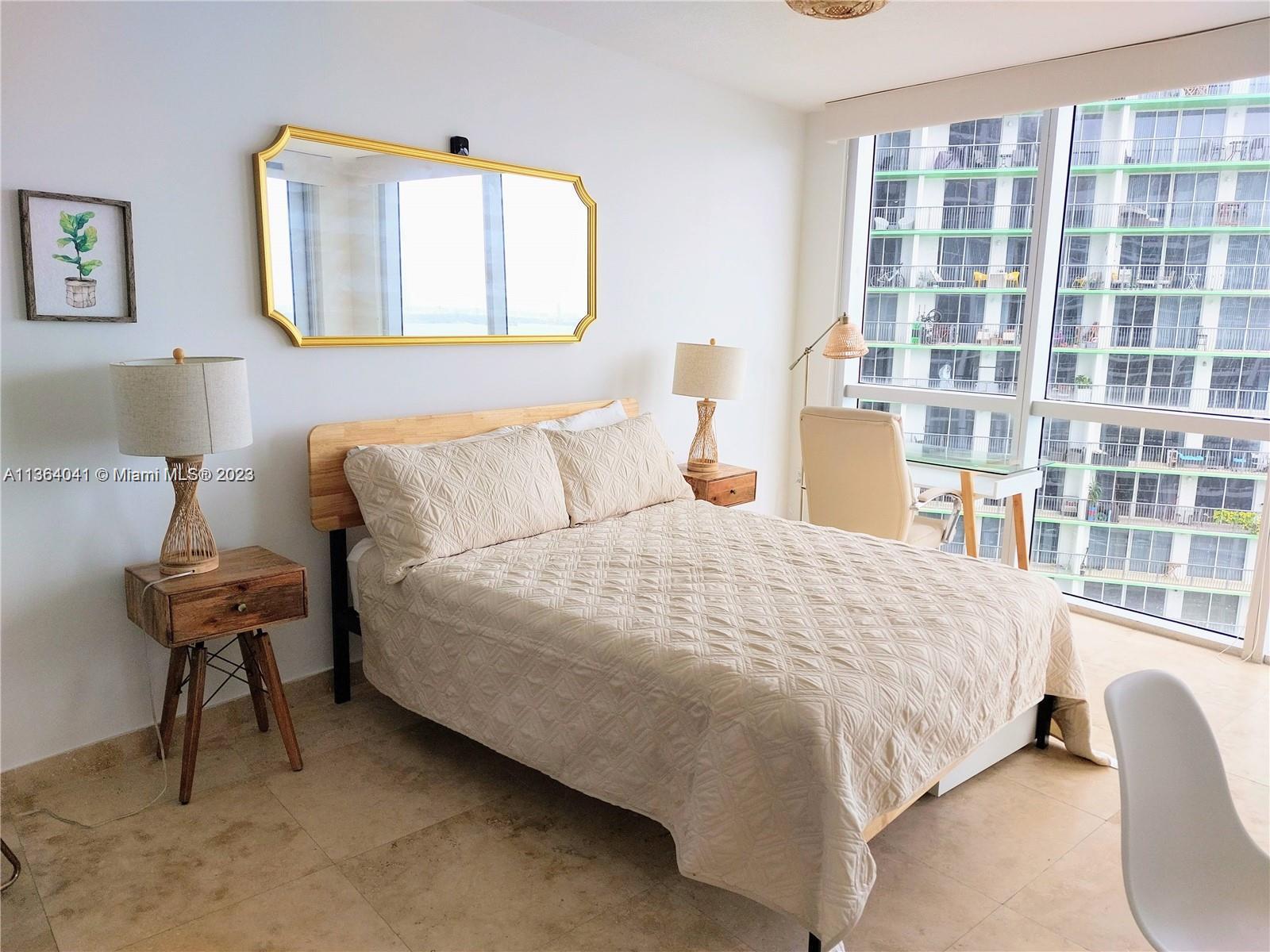 Edgewater Miami, FL 33132 - Photo 4 of 11 a bedroom with a bed and a window