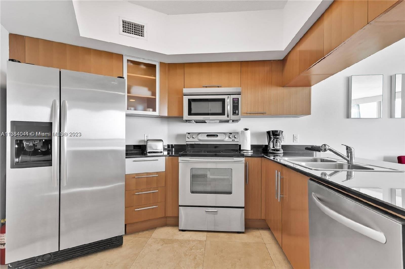 Edgewater Miami, FL 33132 - Photo 6 of 11 a kitchen with a sink stove and refrigerator