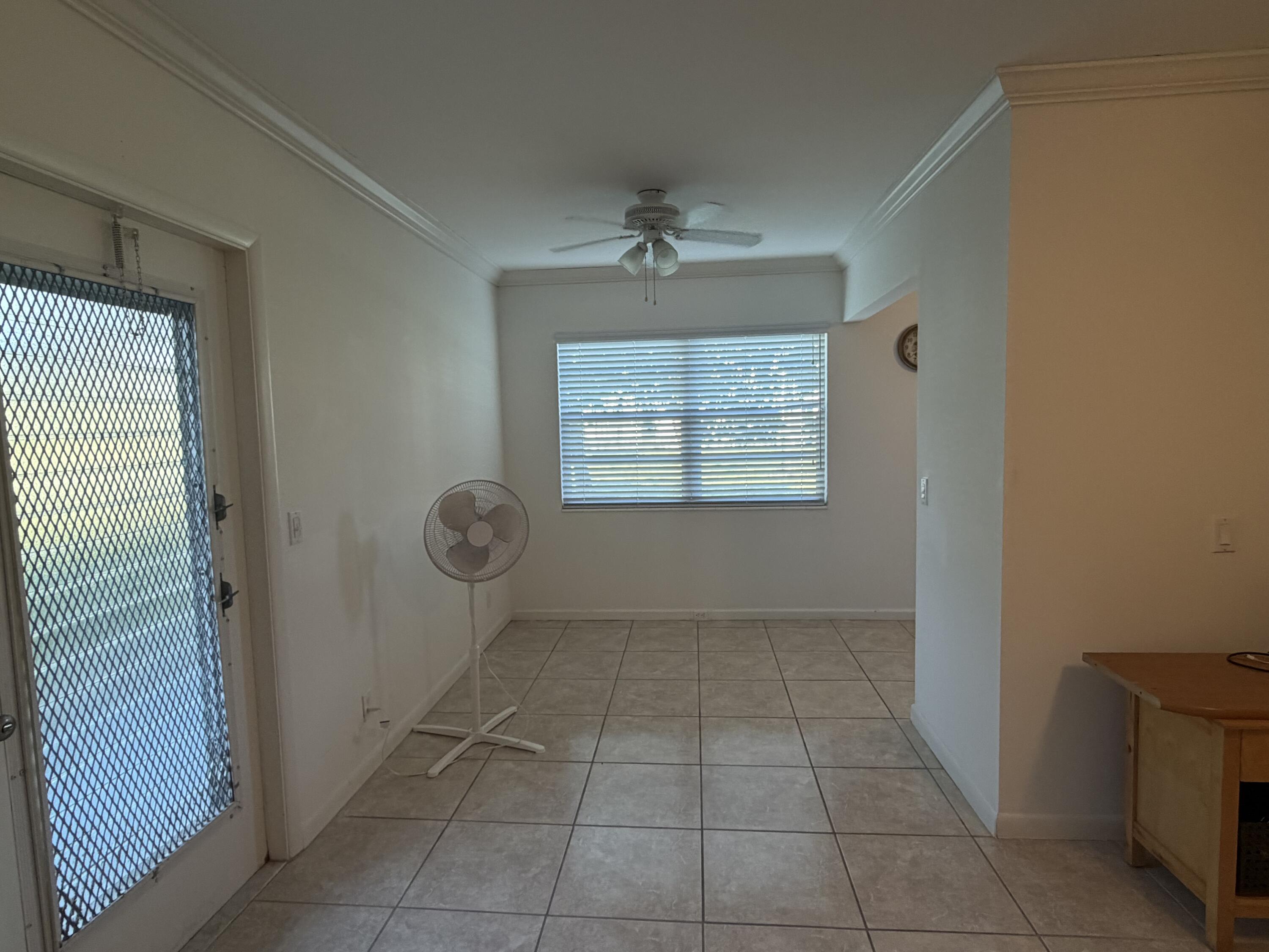 169 Suffolk F Boca Raton, FL 33434 - Photo 4 of 14 an empty room with windows and closet