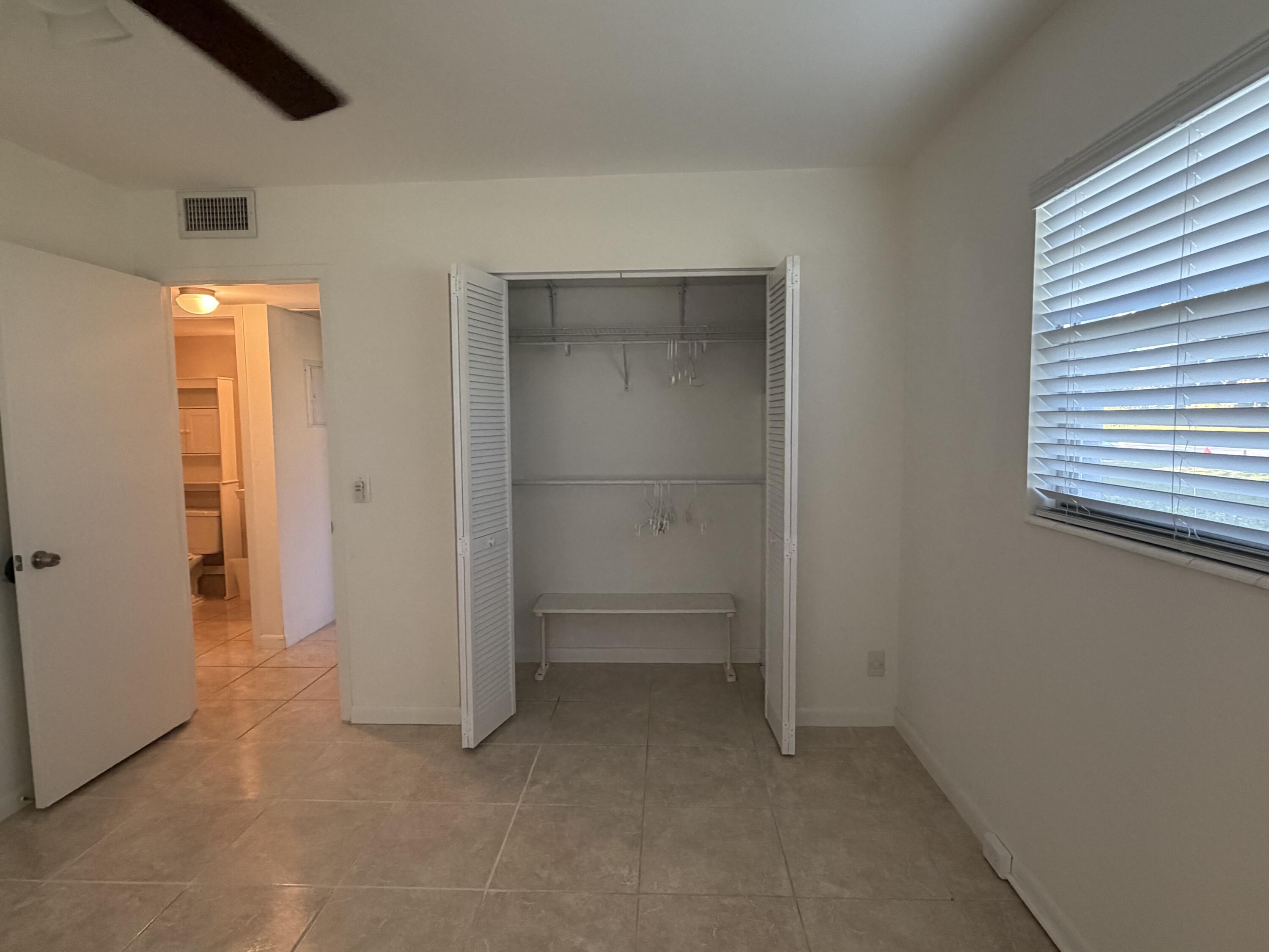 169 Suffolk F Boca Raton, FL 33434 - Photo 8 of 14 an empty room with closet