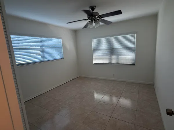 a view of a livingroom with a ceiling fan and window