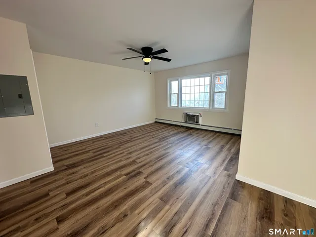wooden floor in an empty room with a window