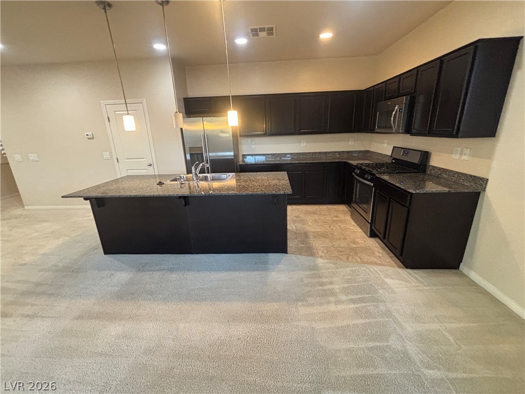 121 Elm Reed Avenue Las Vegas, NV 89113 - Photo 11 of 30 An inviting kitchen with a central island and modern stainless steel appliances awaits culinary adventures.