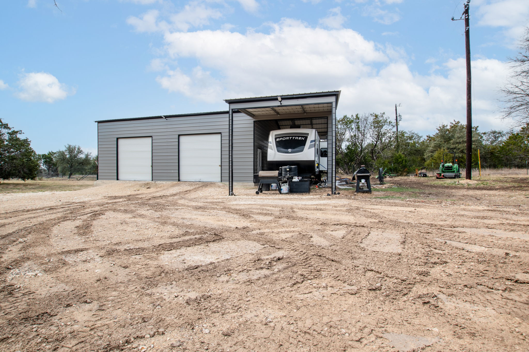 View of outdoor structure featuring driveway
