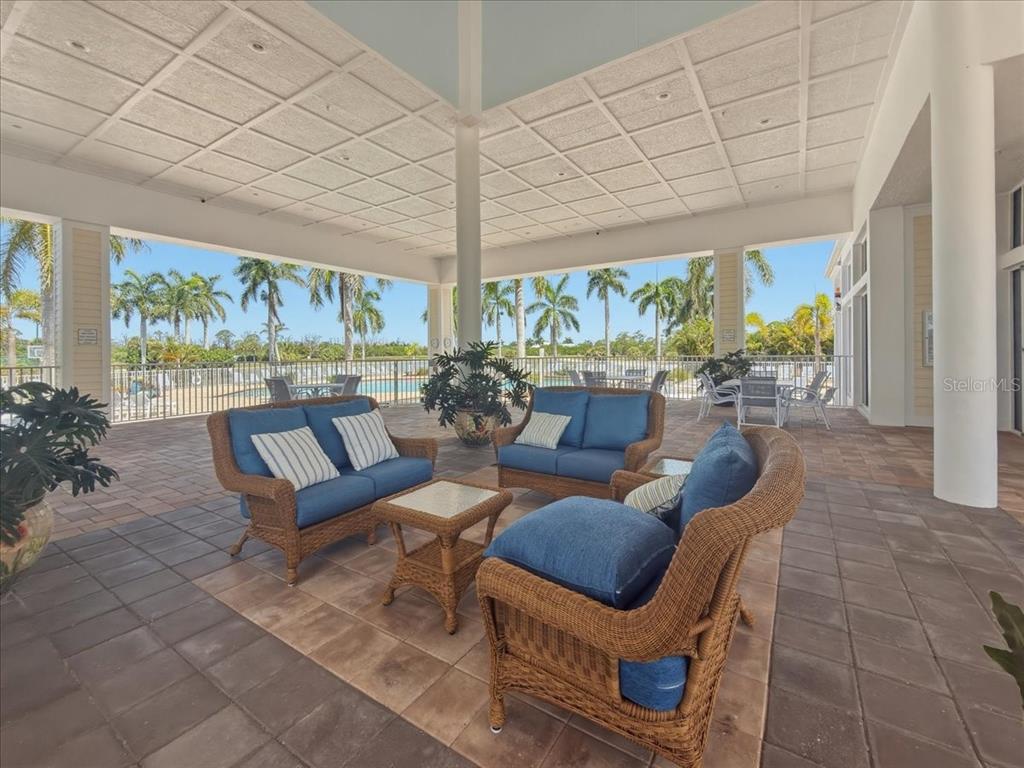 8411 Placida Road, Unit 407 Placida, FL 33946 - Photo 43 of 43 a living room with patio furniture and a floor to ceiling window