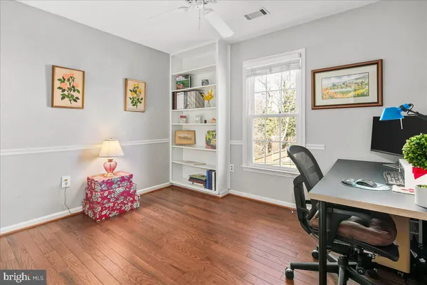 a view of a livingroom with wooden floor and a flat screen tv