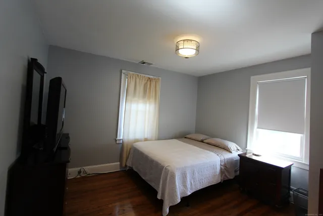 a bedroom with a bed and a window