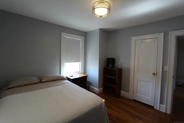 a bedroom with a bed and a closet
