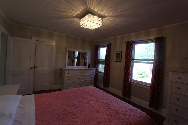 a bed room with a bed and a television