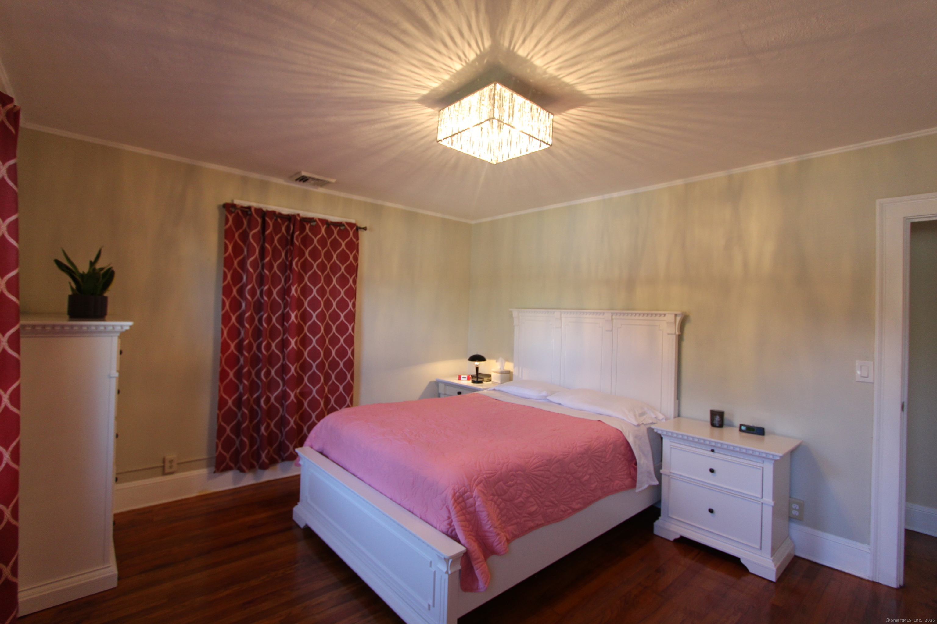 21 Dale Road Wethersfield, CT 06109 - Photo 19 of 25 a bedroom with a bed and a chandelier