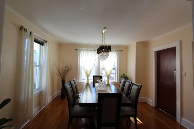 a view of a dining room with furniture window and wooden floor