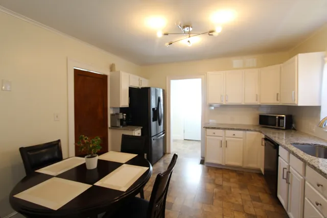 a kitchen with a sink cabinets and refrigerator