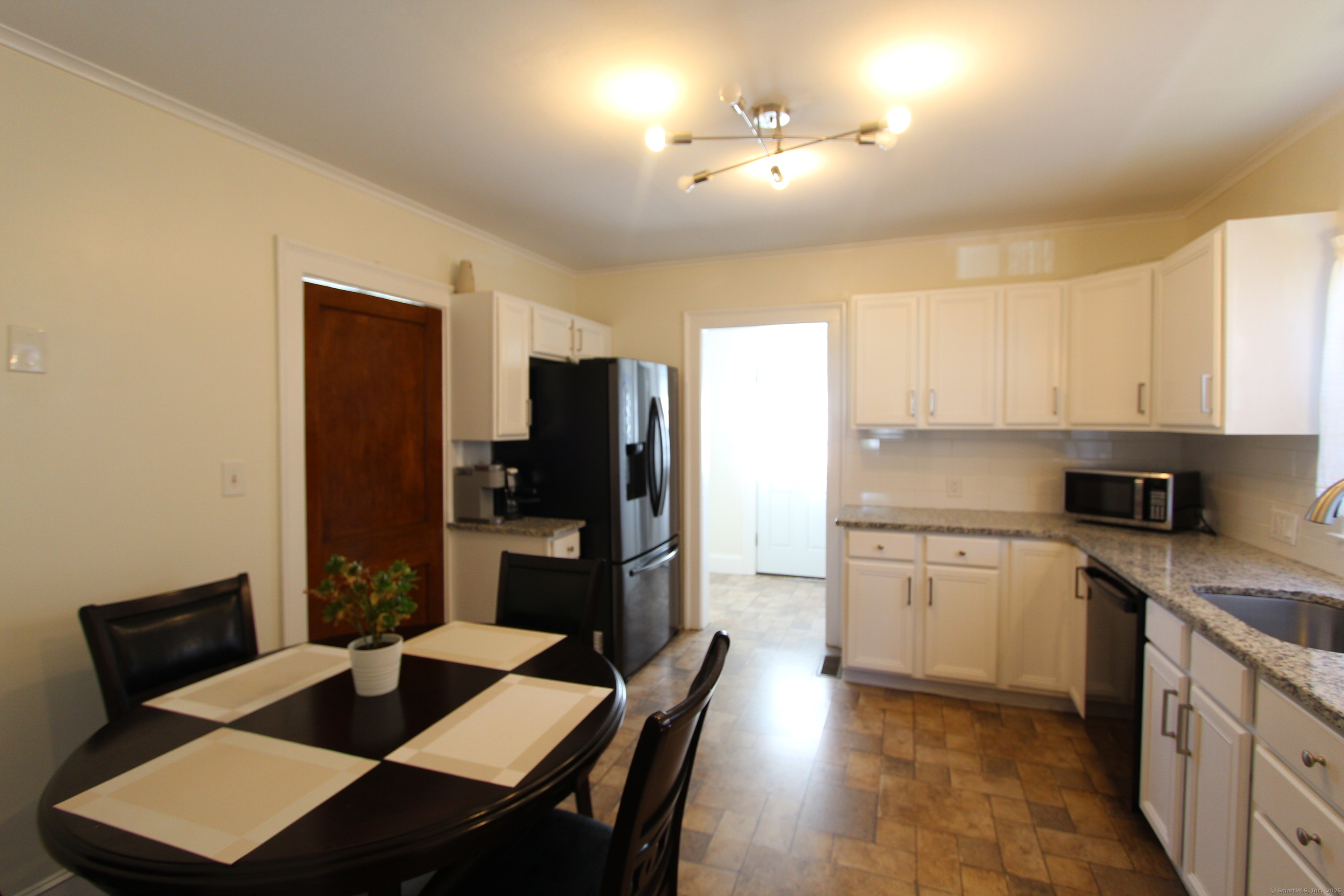 21 Dale Road Wethersfield, CT 06109 - Photo 7 of 25 a kitchen with a sink cabinets and refrigerator