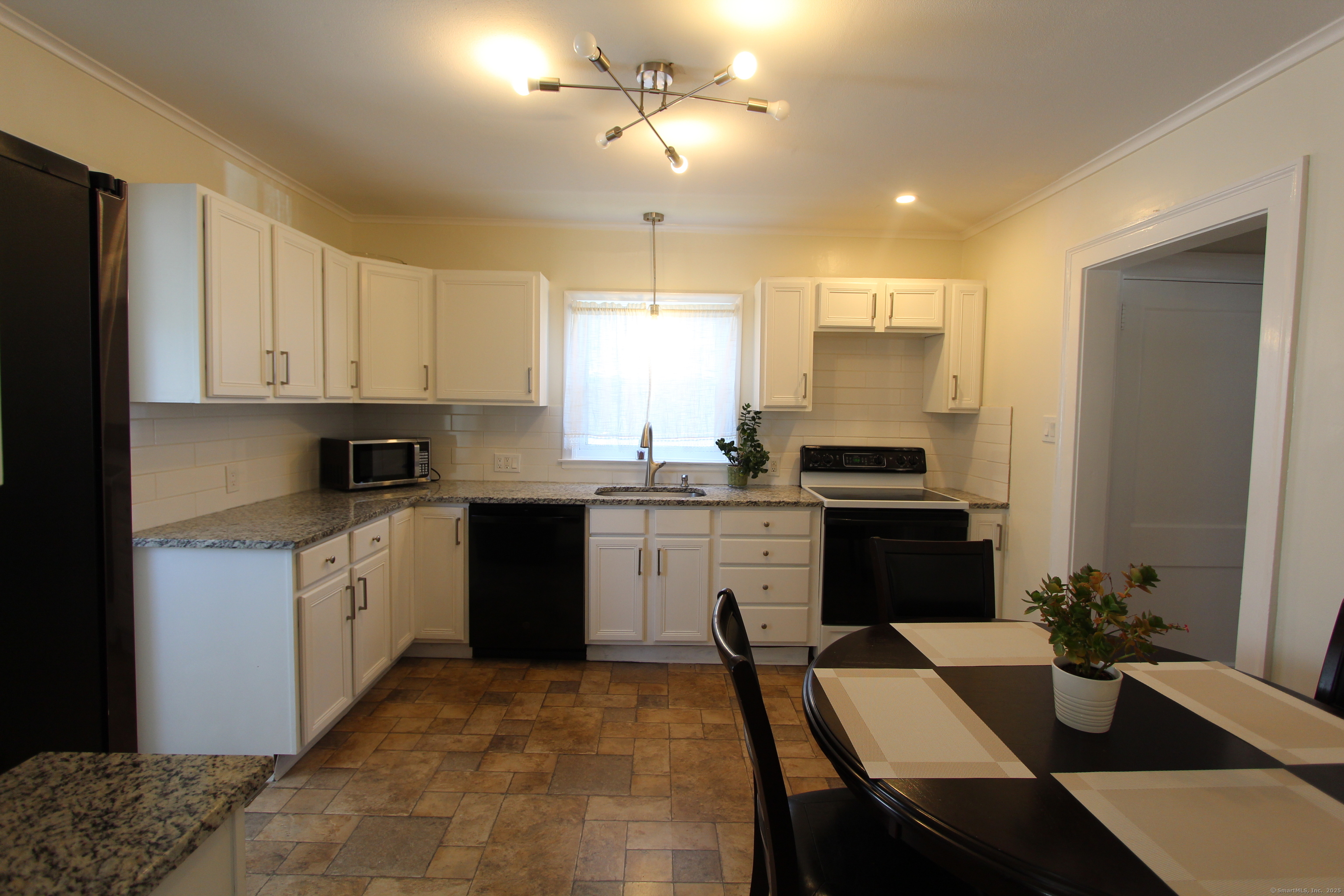 21 Dale Road Wethersfield, CT 06109 - Photo 8 of 25 a kitchen with a refrigerator and a stove top oven