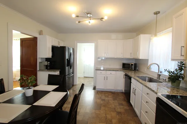 a kitchen with a sink stove and refrigerator