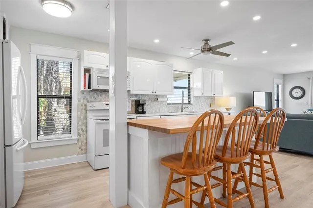 a view of dining room and kitchen with a table chairs a workspace