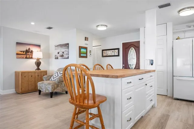 a spacious bedroom with a bed and a dresser