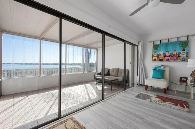 a living room with furniture and a floor to ceiling window