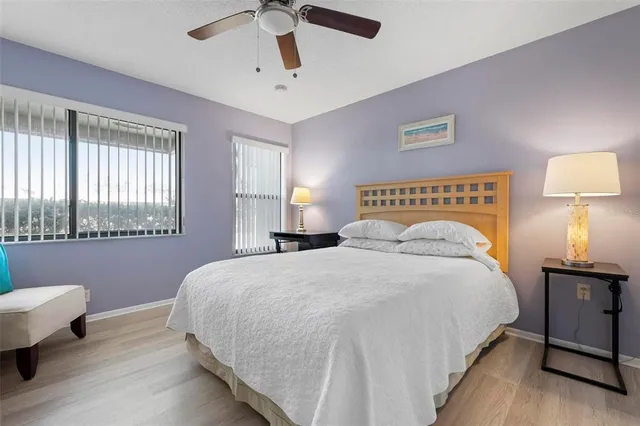 a bedroom with a bed and a lamp on dresser