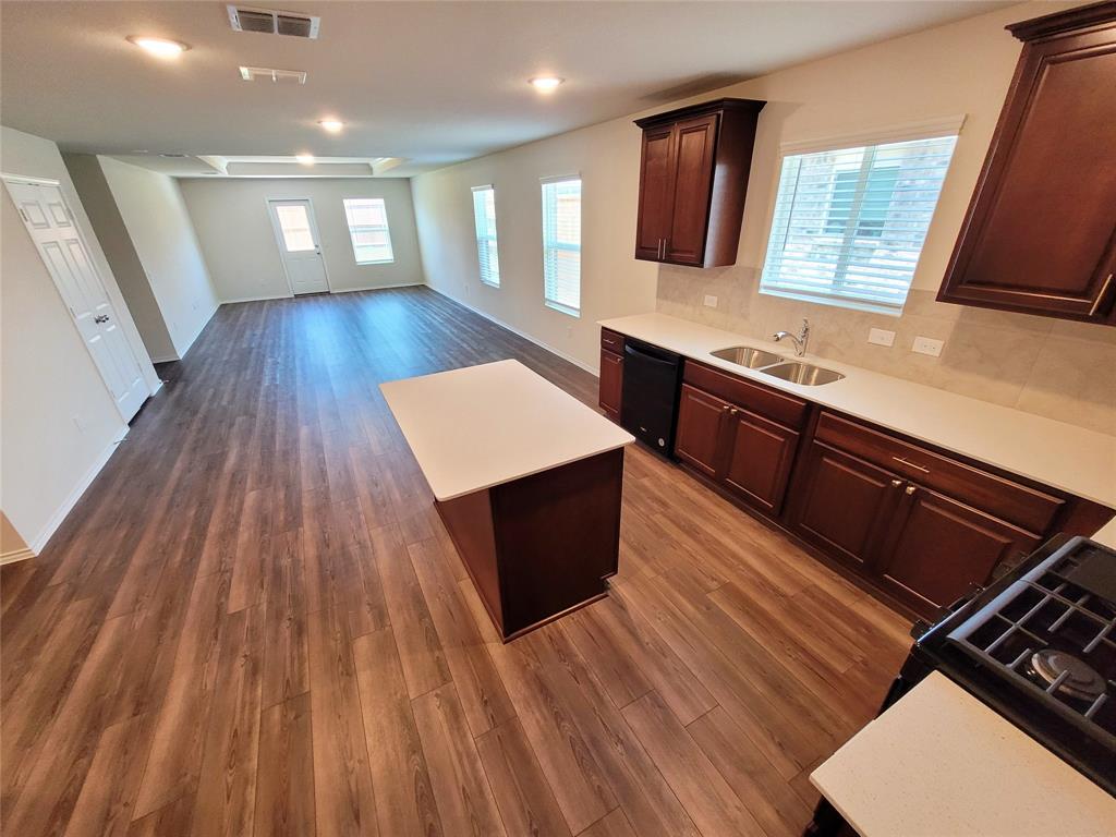 16029 Pemberly Lane Haslet, TX 76052 - Photo 6 of 19 a kitchen with wooden floors and a sink