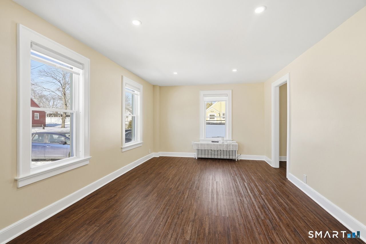 206 Gale Avenue Meriden, CT 06450 - Photo 7 of 33 a view of a big room with wooden floor and windows