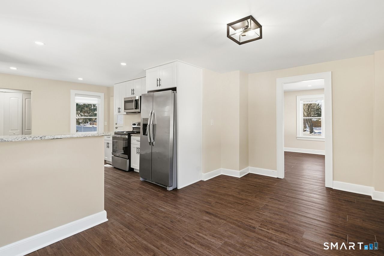 206 Gale Avenue Meriden, CT 06450 - Photo 9 of 33 a view of a kitchen with a refrigerator wooden floor and a window