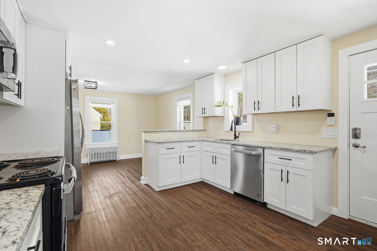 206 Gale Avenue Meriden, CT 06450 - Photo 10 of 33 a kitchen with granite countertop white cabinets and white appliances