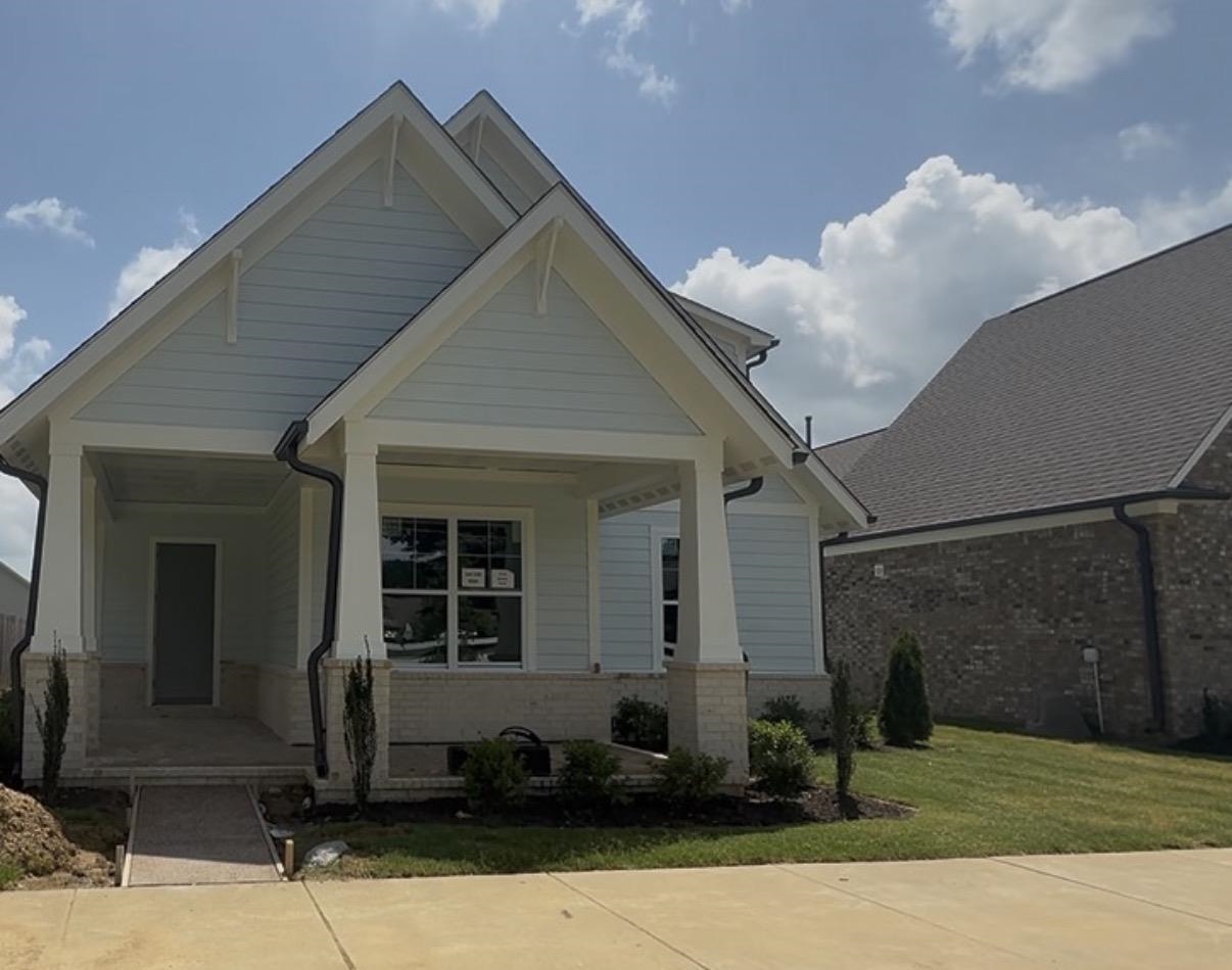 5710 Gerber Road Arlington, TN 38002 - Photo 1 of 3 Craftsman-style home featuring light blue siding with white trim accents and a covered front porch