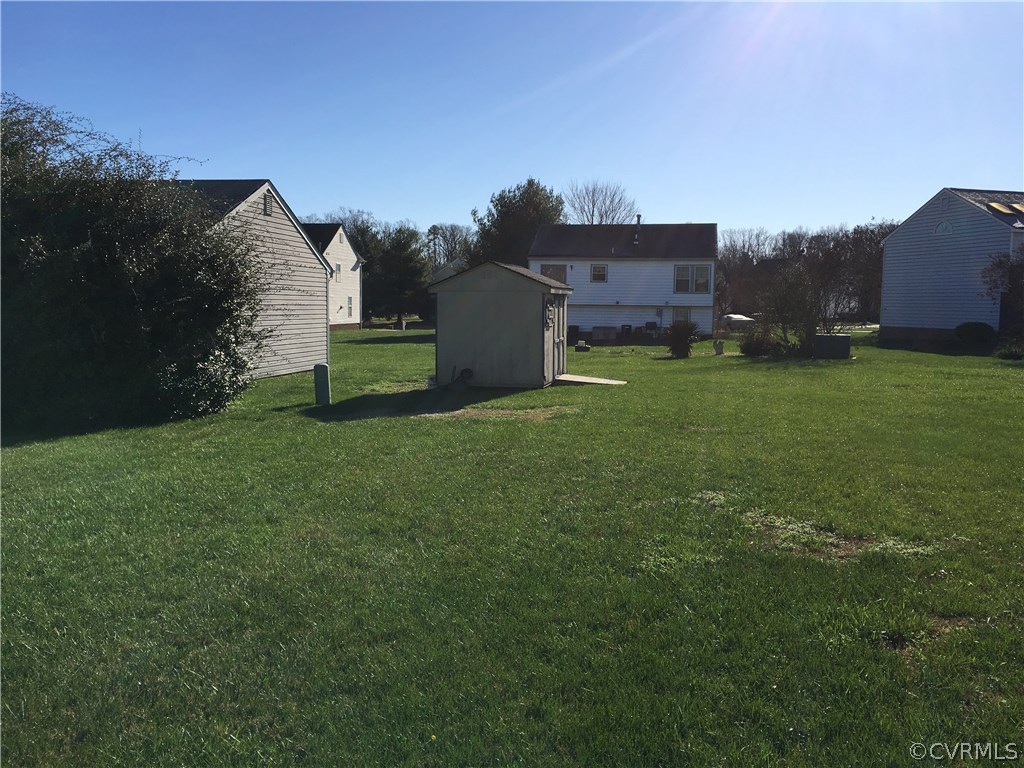 1565 Tree Ridge Road Richmond, VA 23231 - Photo 6 of 14 a view of a big house with a big yard and large trees