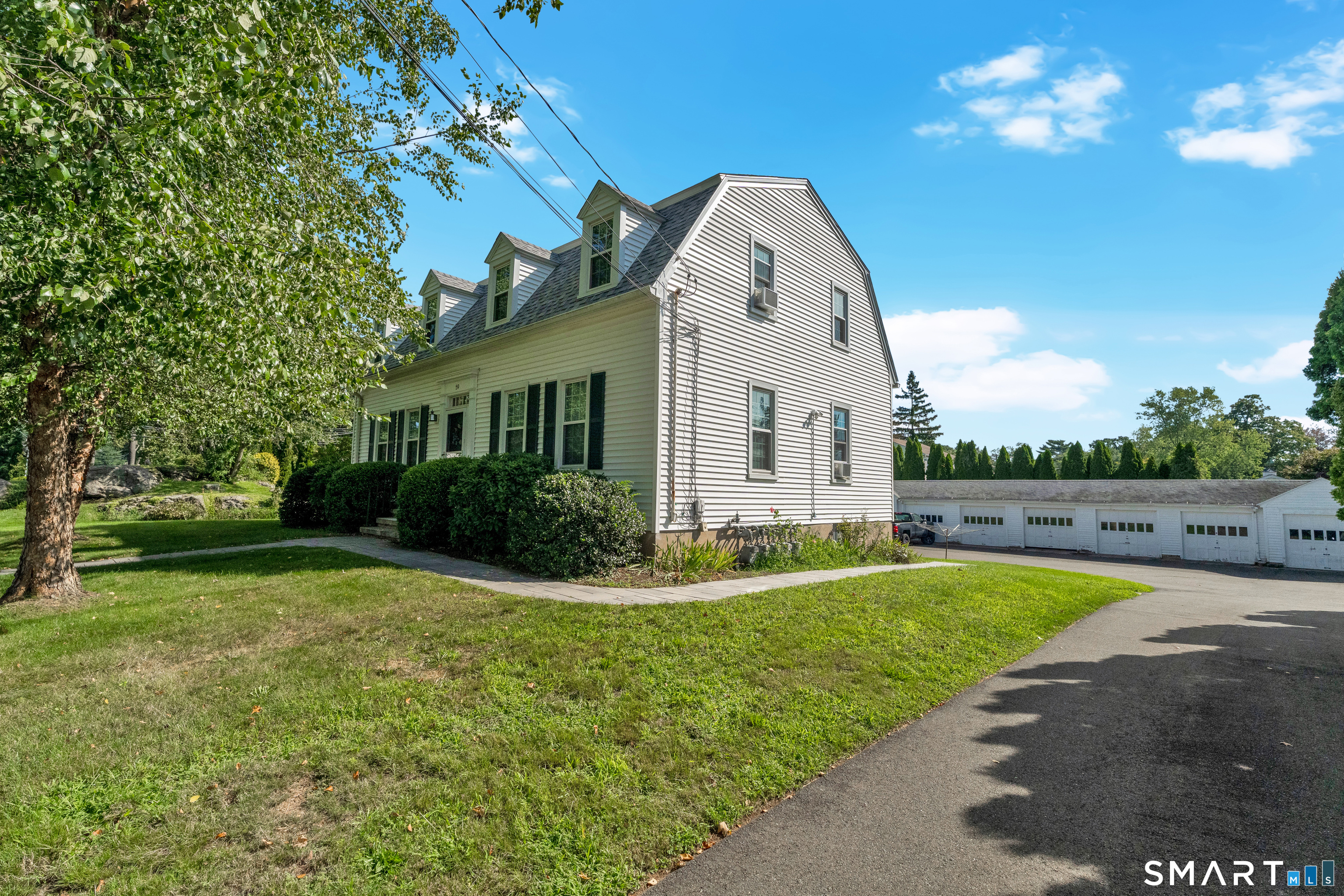 59 Spring Rock Road Branford, CT 06405 - Photo 5 of 38 Side View with driveway and garages