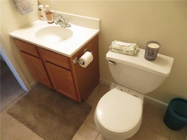 a bathroom with a toilet a sink and mirror