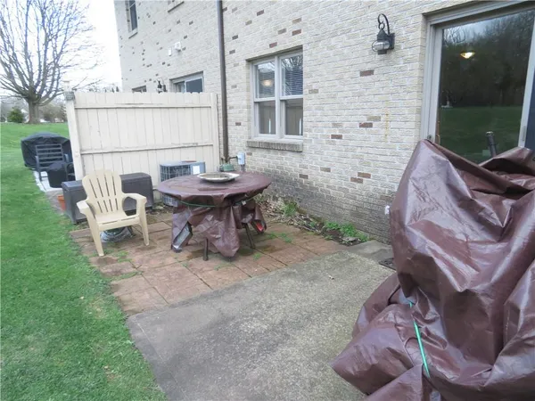 a view of a patio with table and chairs