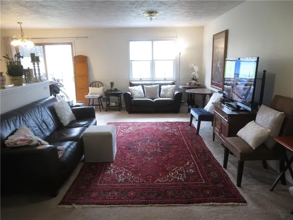 a living room with furniture rug and window