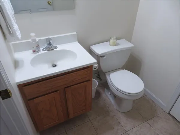 a white toilet sitting next to a bathroom sink