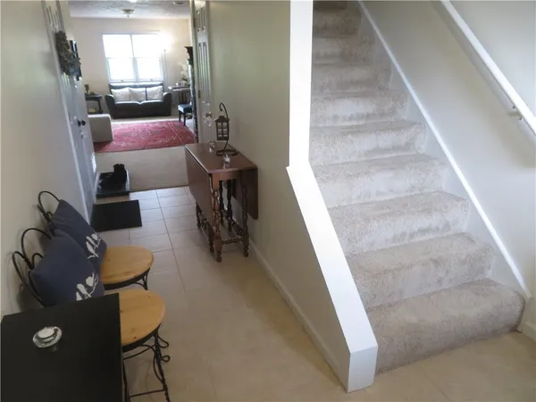 a living room with couches and furniture with kitchen view