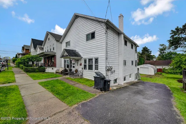 a view of house that has a yard