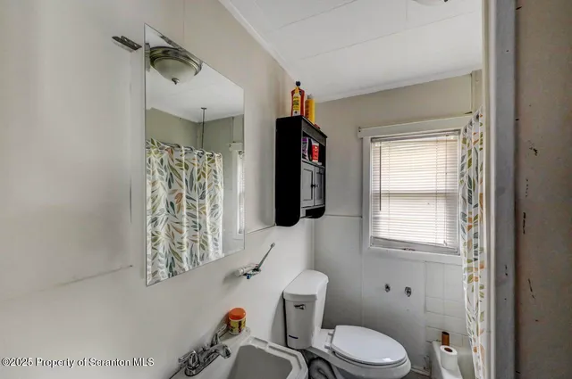 a bathroom with a toilet sink and shower