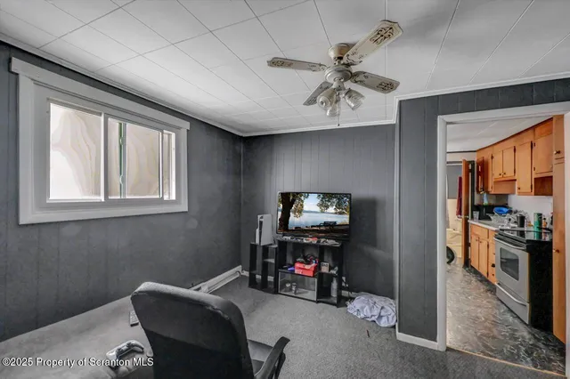 a view of a livingroom with furniture and a flat screen tv