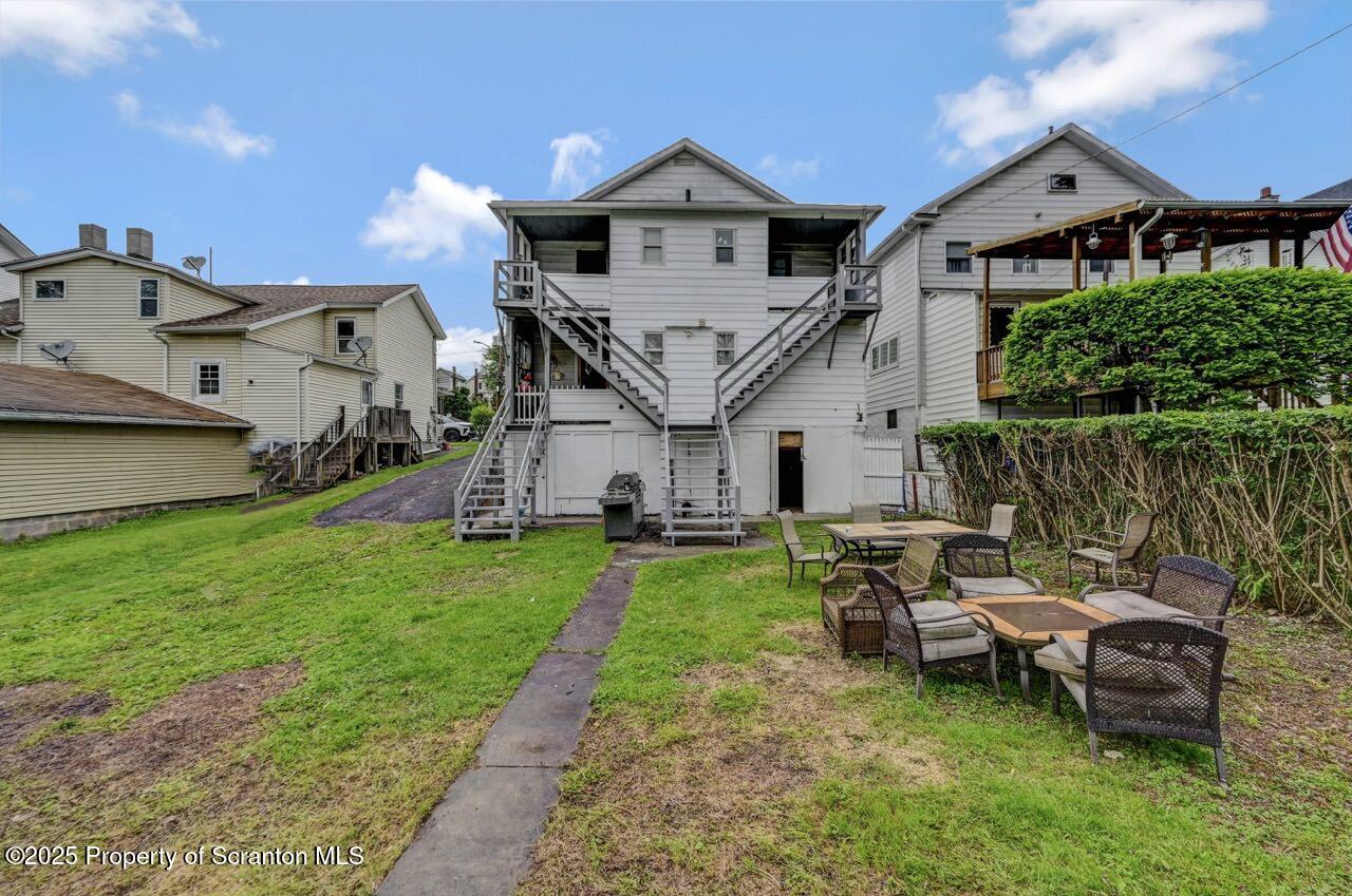 1223 Eynon Street Scranton, PA 18504 - Photo 3 of 42 a view of a house with a big yard and a large tree in front of it