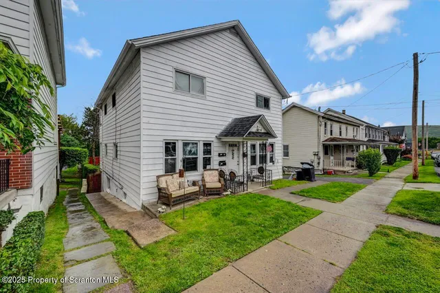 a view of a house with sitting area and garden