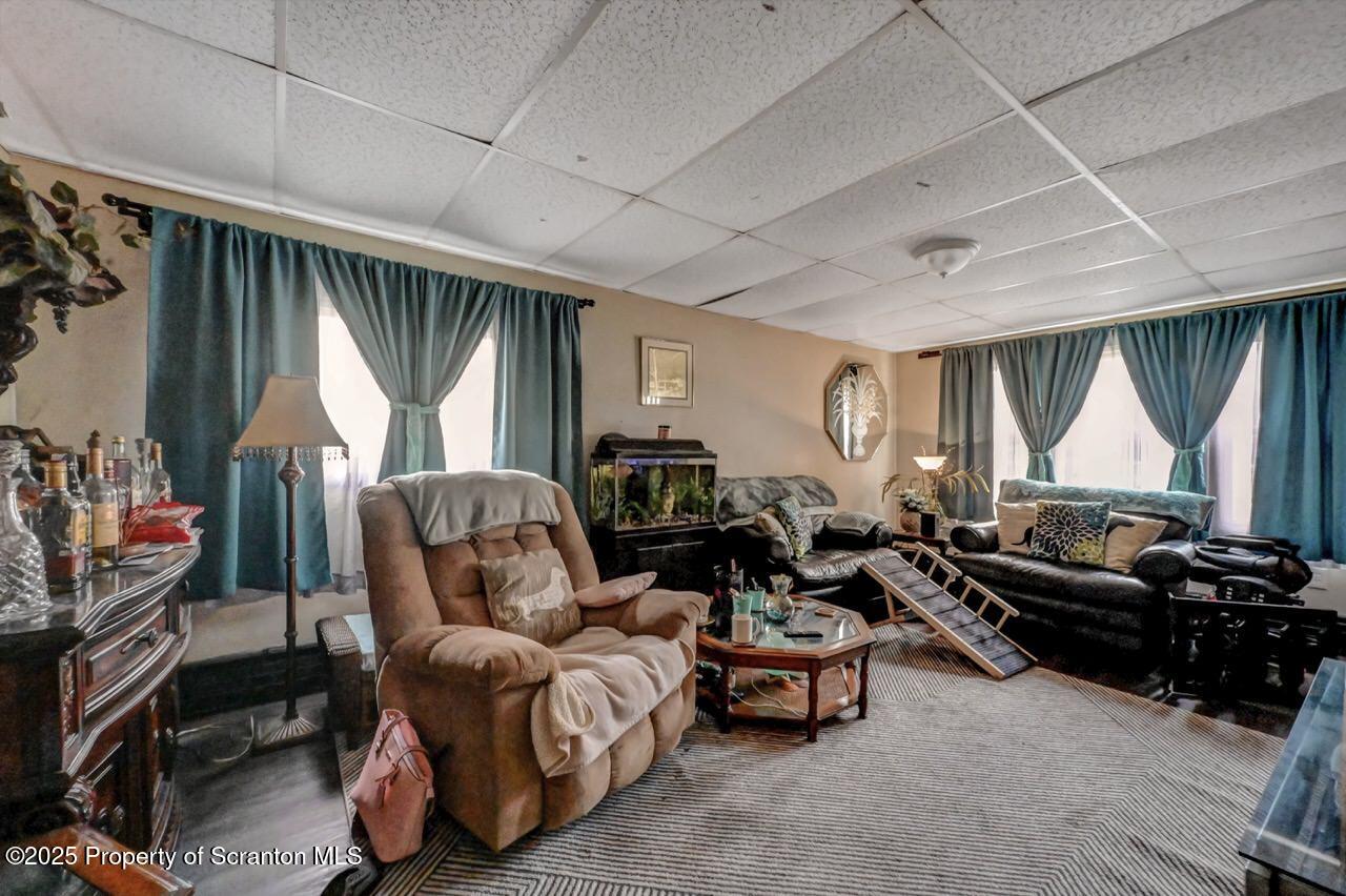1223 Eynon Street Scranton, PA 18504 - Photo 5 of 42 a living room with furniture a large window and a flat screen tv