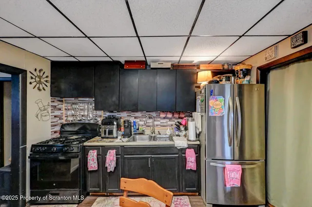 a kitchen with refrigerator and stove