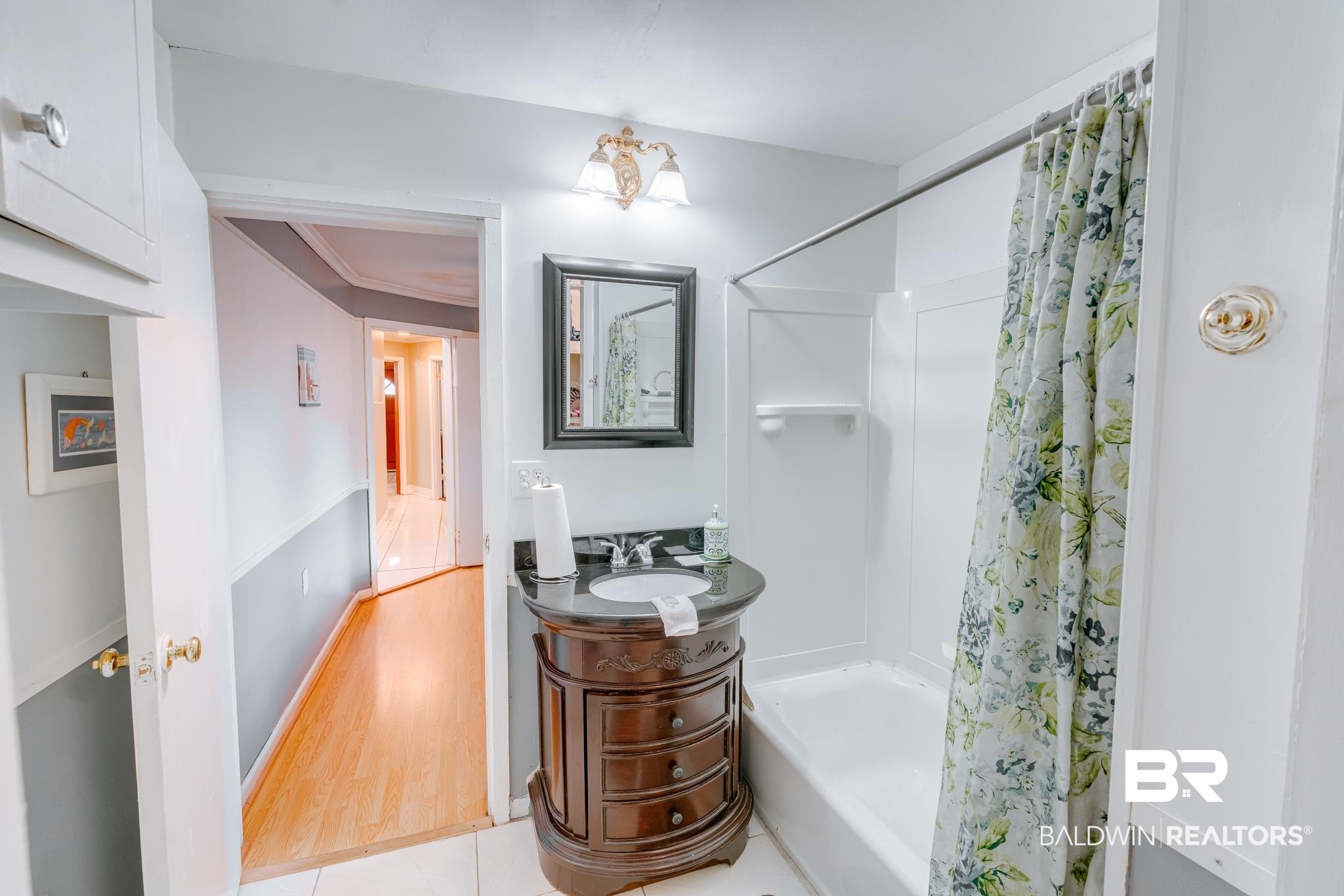 315 Fourth Avenue Chickasaw, AL 36611 - Photo 24 of 28 Full bathroom with vanity, shower / tub combo, and wood finished floors