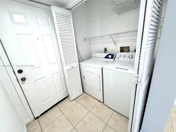 a view of storage and utility room with washer and dryer