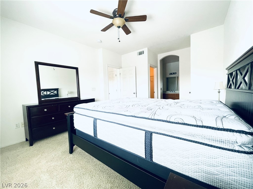 7701 West Robindale Road, Unit 206 Las Vegas, NV 89113 - Photo 15 of 30 Soft wall-to-wall carpeting and clean white walls anchor this airy primary bedroom suite.