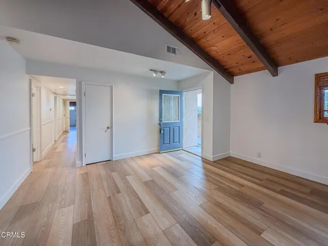 a view of a hallway with wooden floor