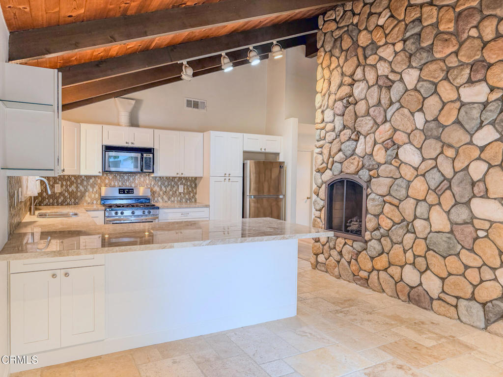 5142 Sandpiper Way Oxnard, CA 93035 - Photo 18 of 51 a view of a kitchen with granite countertop cabinets
