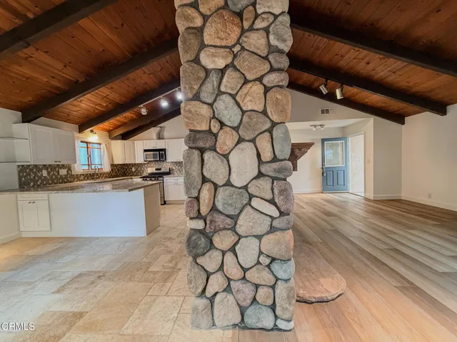 a view of empty room with fireplace and wooden floor